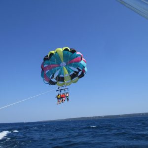 a parachute is flying over a body of water
