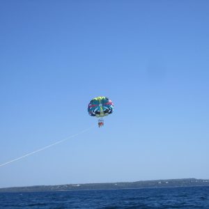 a man flying a kite in a body of water